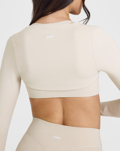 SoftMotion™ Long Sleeve Shrug with White Logo | Sand