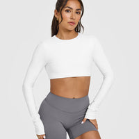 SoftMotion™ Long Sleeve Crop Top with White Logo | White
