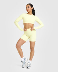 SoftMotion™ Long Sleeve Crop Top with White Logo | Pastel Yellow