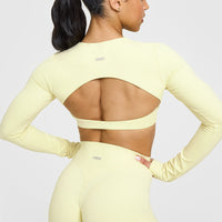 SoftMotion™ Long Sleeve Crop Top with White Logo | Pastel Yellow