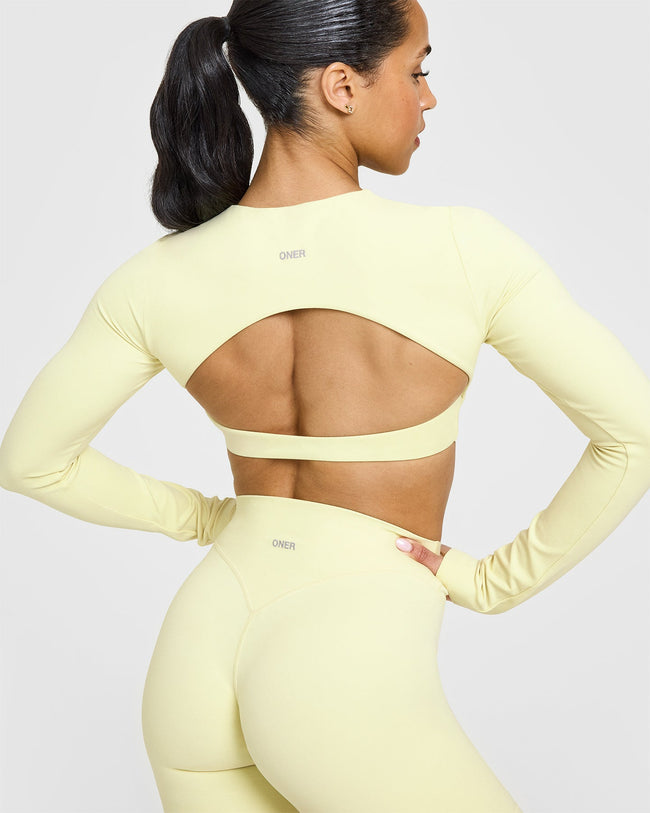 SoftMotion™ Long Sleeve Crop Top with White Logo | Pastel Yellow