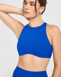 SoftMotion™ High Neck Sports Bra with White Logo | Light Cobalt Blue