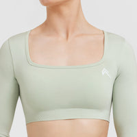 Effortless Square Neck Crop Long Sleeve Top with White Logo | Tea Green