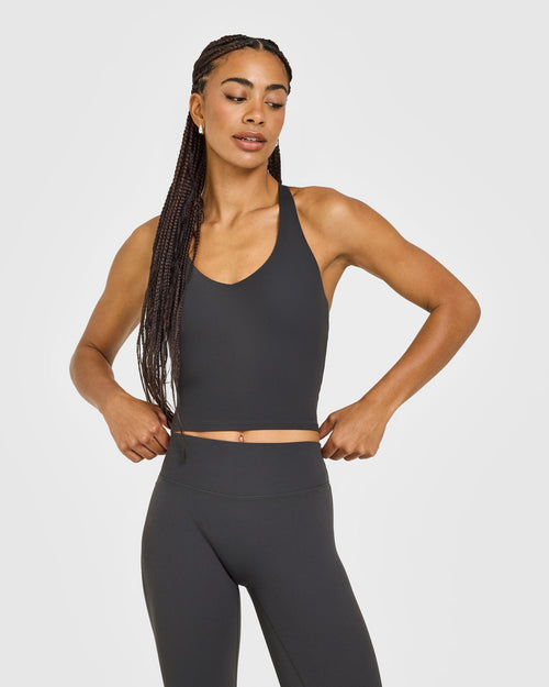 Oner Modal SoftMotion™ Racer Back Mid Vest with Built in Bra Shelf with White Logo | Coal