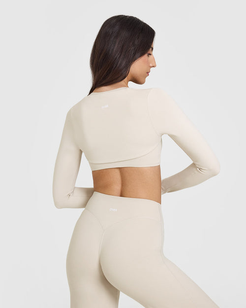 SoftMotion™ Long Sleeve Shrug with White Logo | Sand