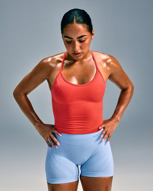 EnhanceLift™ Seamless Strappy Racer Vest with Built in Bra Shelf with Grey Logo | Dark Charged Coral
