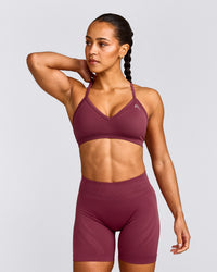 EnhanceLift™ Seamless Strappy Sports Bra with Grey Logo | Burnt Maroon Red