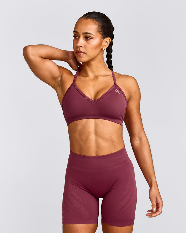 EnhanceLift™ Seamless Strappy Sports Bra with Grey Logo | Burnt Maroon Red