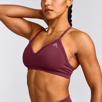 EnhanceLift™ Seamless Strappy Sports Bra with Grey Logo | Burnt Maroon Red