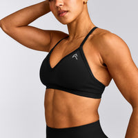 EnhanceLift™ Seamless Strappy Sports Bra with Grey Logo | Black