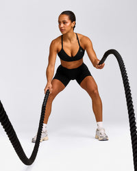 EnhanceLift™ Seamless Strappy Sports Bra with Grey Logo | Black