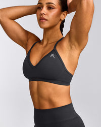 EnhanceLift™ Seamless Strappy Sports Bra with Grey Logo | Coal