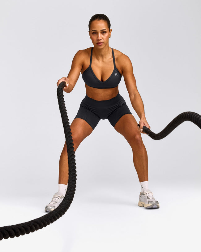 EnhanceLift™ Seamless Strappy Sports Bra with Grey Logo | Coal