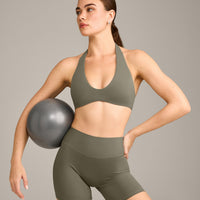 SoftMotion™ Minimal Halter Neck Bralette with Grey Logo | Alpine Green