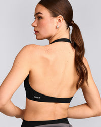 SoftMotion™ Minimal Halter Neck Bralette with Grey Logo | Black