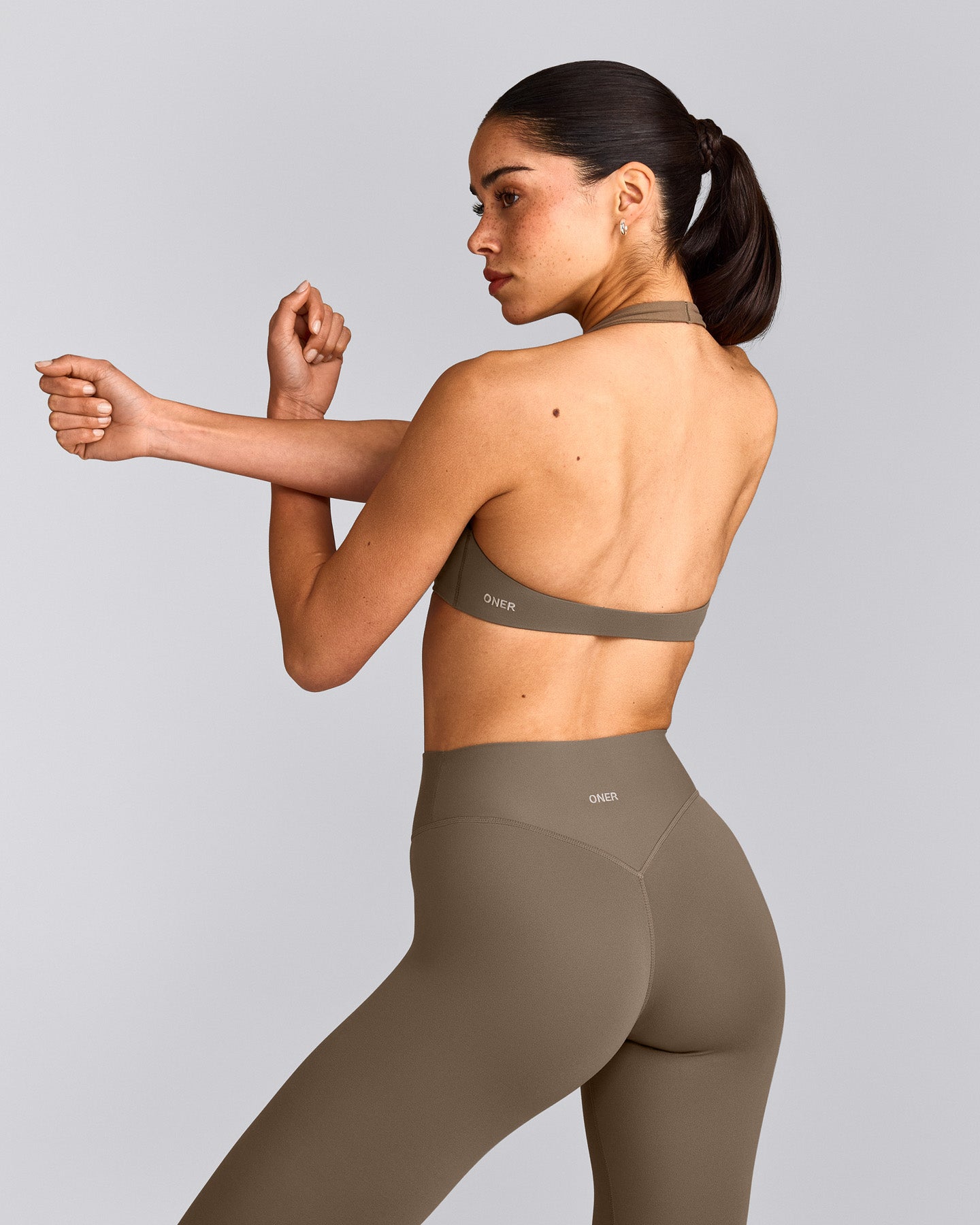 SoftMotion™ Minimal Halter Neck Bralette with Grey Logo | Moss Brown