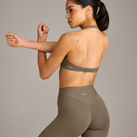 SoftMotion™ Minimal Halter Neck Bralette with Grey Logo | Moss Brown