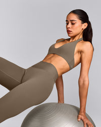 SoftMotion™ Minimal Halter Neck Bralette with Grey Logo | Moss Brown