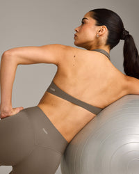 SoftMotion™ Minimal Halter Neck Bralette with Grey Logo | Moss Brown