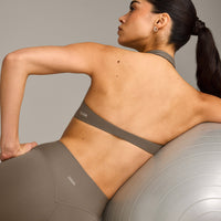 SoftMotion™ Minimal Halter Neck Bralette with Grey Logo | Moss Brown