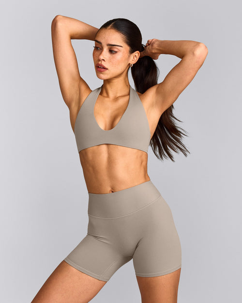 SoftMotion™ Minimal Halter Neck Bralette with White Logo | Warm Sand
