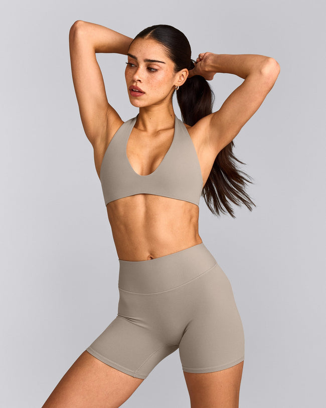 SoftMotion™ Minimal Halter Neck Bralette with White Logo | Warm Sand