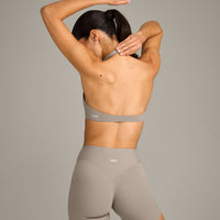 SoftMotion™ Minimal Halter Neck Bralette with White Logo | Warm Sand