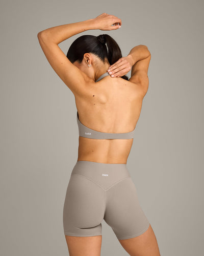 SoftMotion™ Minimal Halter Neck Bralette with White Logo | Warm Sand