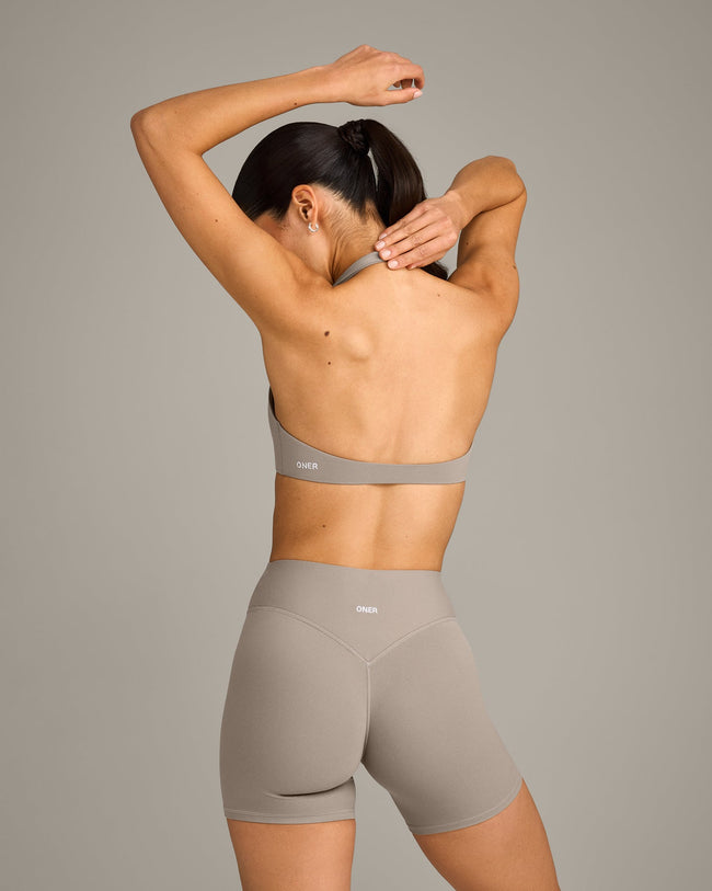 SoftMotion™ Minimal Halter Neck Bralette with White Logo | Warm Sand