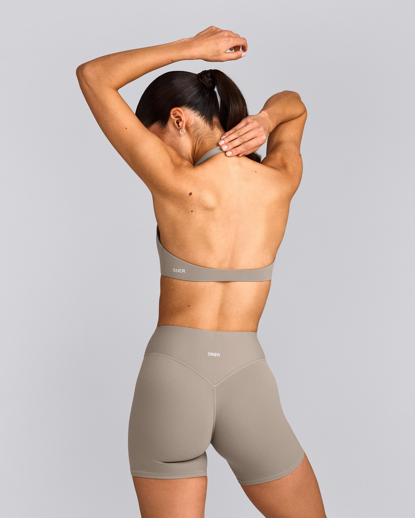 SoftMotion™ Minimal Halter Neck Bralette with White Logo | Warm Sand