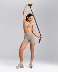 SoftMotion™ Minimal Halter Neck Bralette with White Logo | Warm Sand