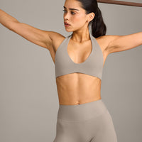 SoftMotion™ Minimal Halter Neck Bralette with White Logo | Warm Sand