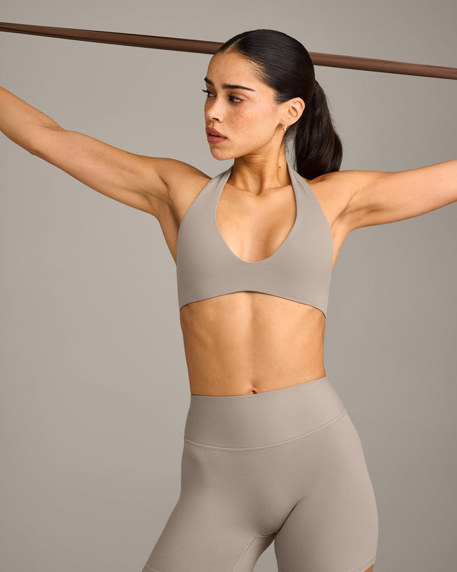SoftMotion™ Minimal Halter Neck Bralette with White Logo | Warm Sand