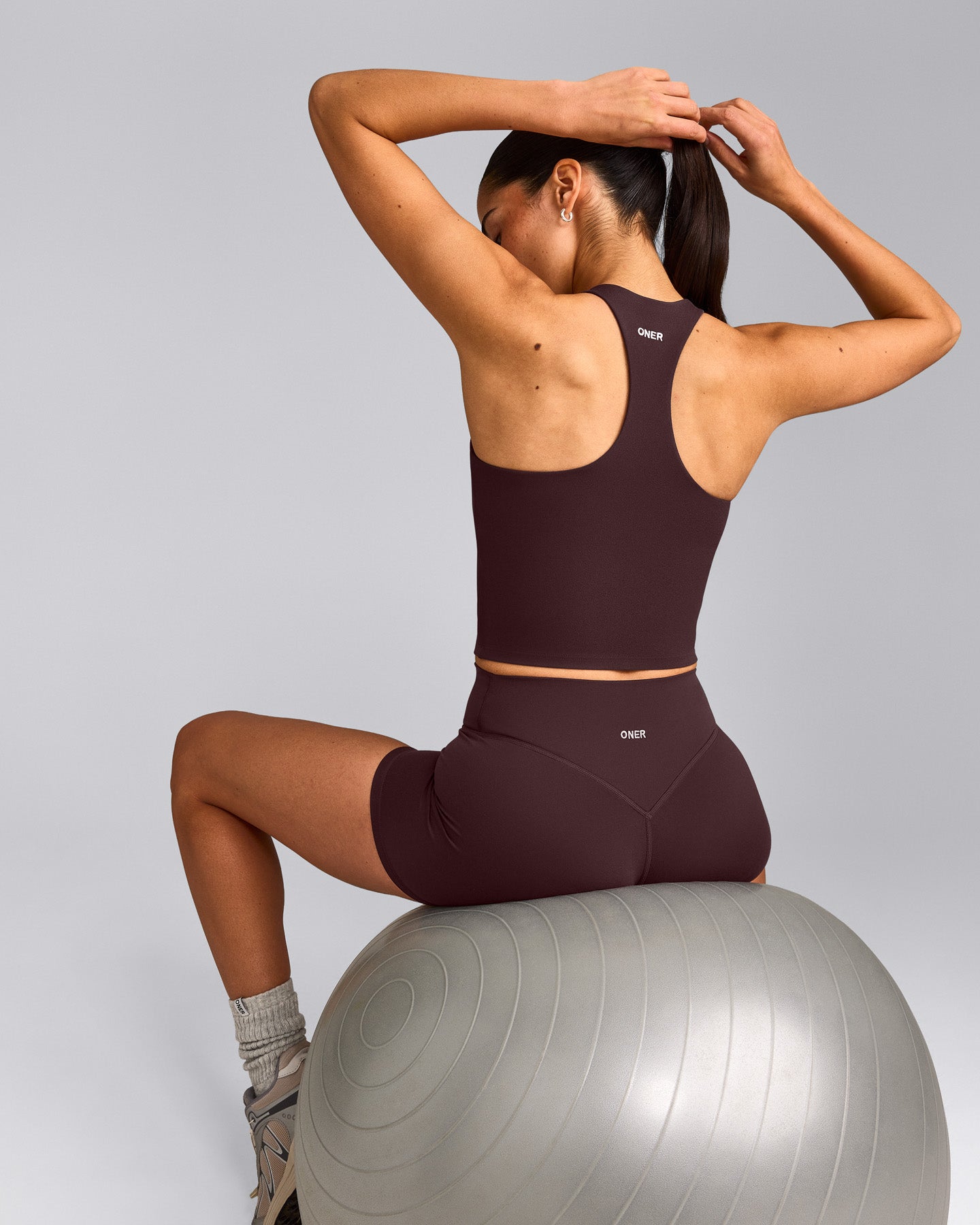SoftMotion™ Racer Back Mid Vest with Built in Bra Shelf with Grey Logo | Plum Brown
