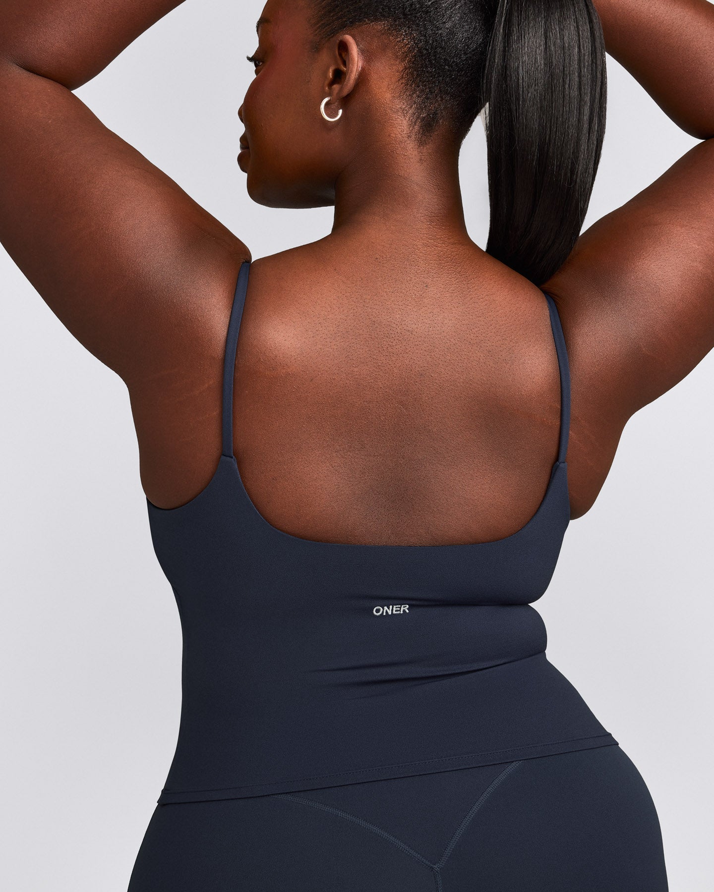 SoftMotion™ Strappy Mid Vest with Built in Bra Shelf with Grey Logo | True Blue