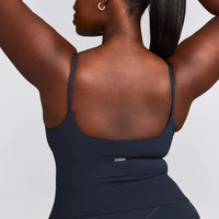 SoftMotion™ Strappy Mid Vest with Built in Bra Shelf with Grey Logo | True Blue