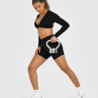 Unified Twist Front Long Sleeve Crop Top White Logo | Black