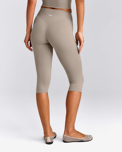 SoftMotion™ High Waisted Capri Leggings with White Logo | Warm Sand