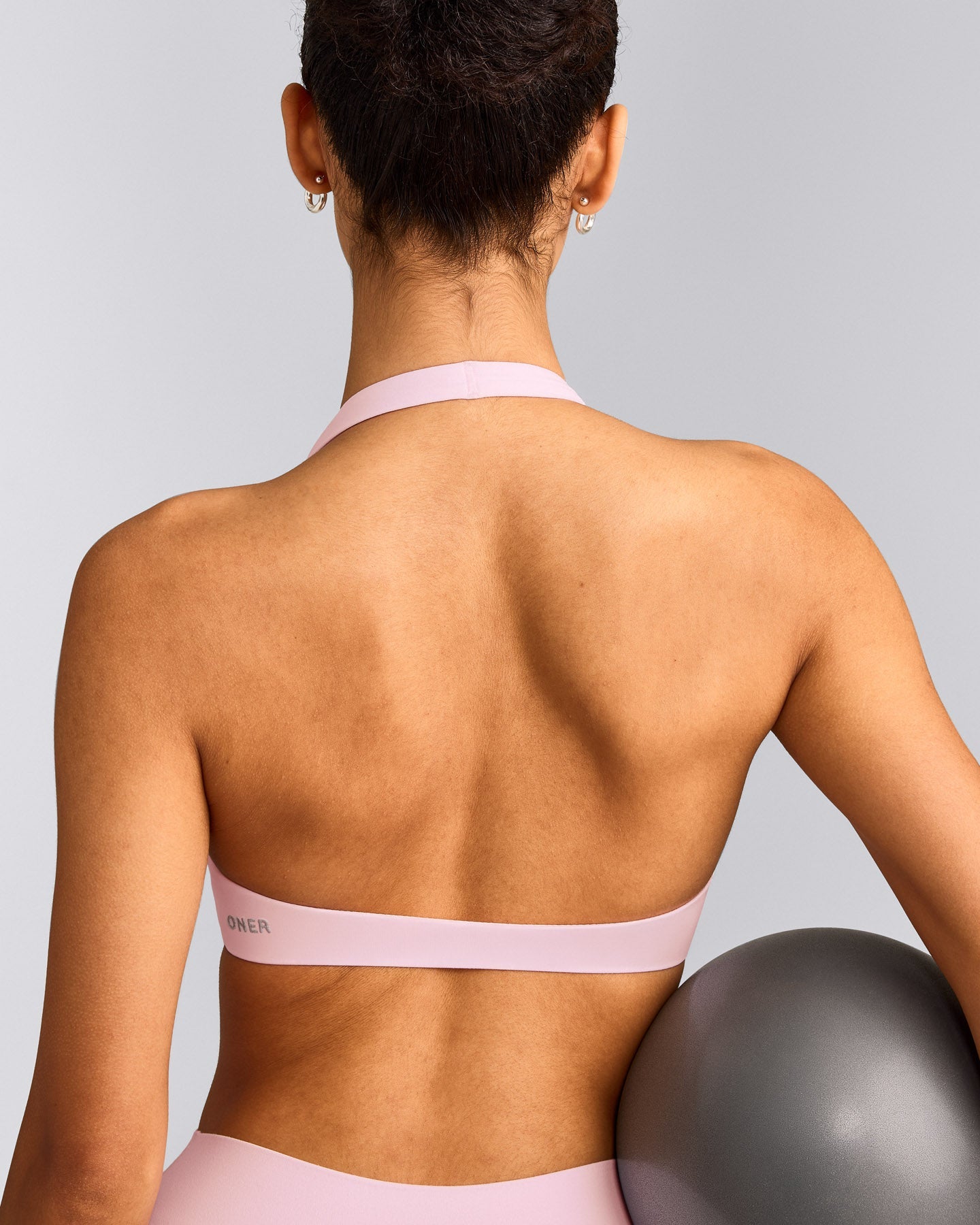SoftMotion™ Minimal Halter Neck Bralette with Grey Logo | Soft Girl Pink