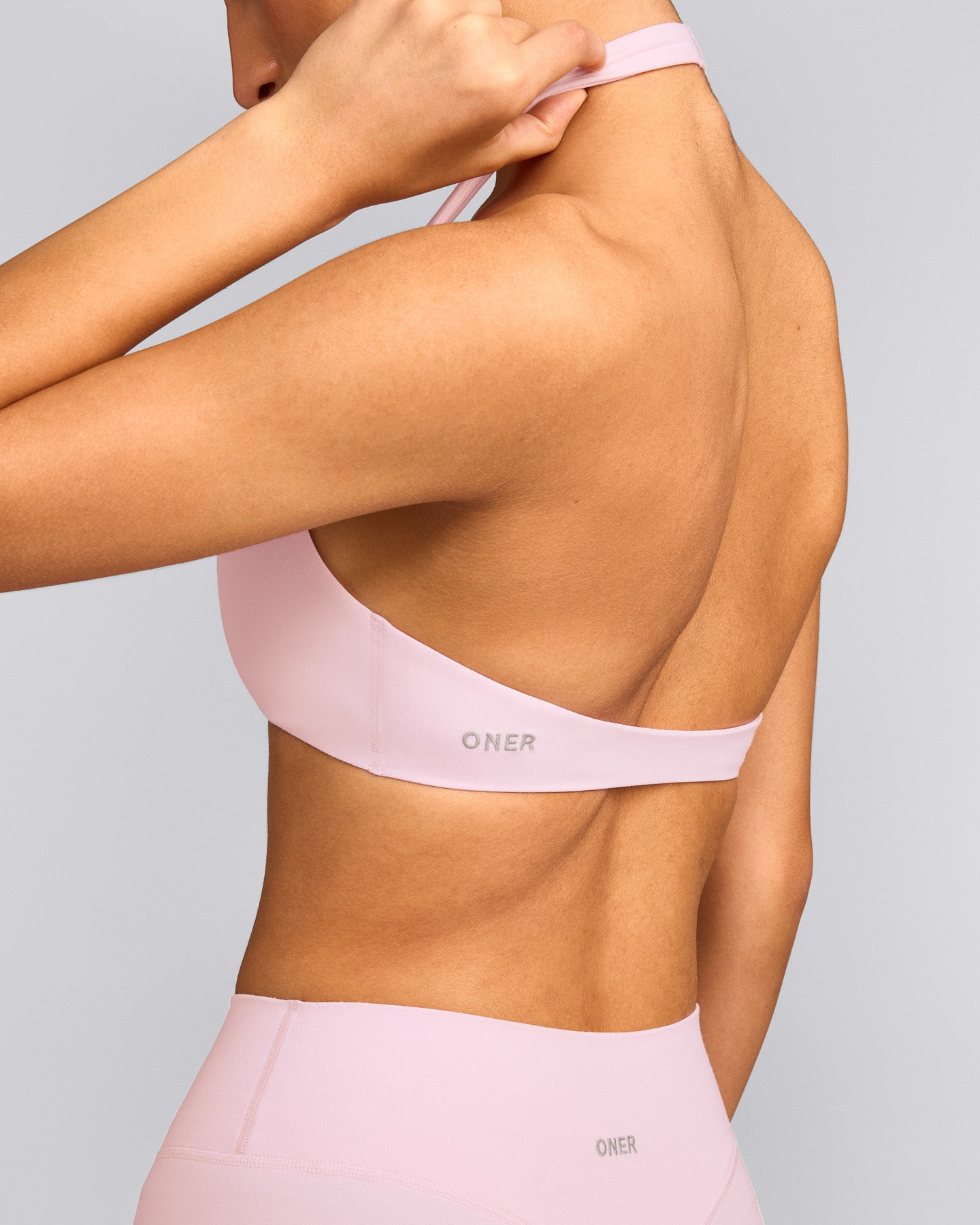 SoftMotion™ Minimal Halter Neck Bralette with Grey Logo | Soft Girl Pink