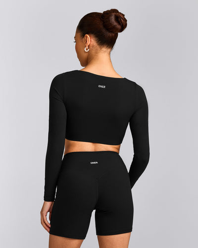 SoftMotion™ Scoop Neck Long Sleeve Crop Top with Built in Bra Shelf with Grey Logo | Black