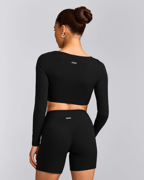SoftMotion™ Scoop Neck Long Sleeve Crop Top with Built in Bra Shelf with Grey Logo | Black