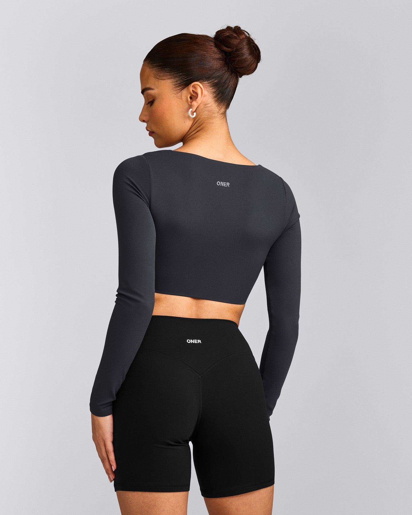 SoftMotion™ Scoop Neck Long Sleeve Crop Top with Built in Bra Shelf with Grey Logo | Coal