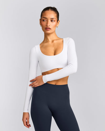 SoftMotion™ Scoop Neck Long Sleeve Crop Top with Built in Bra Shelf with Grey Logo | White