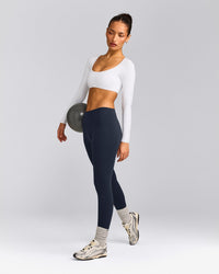 SoftMotion™ Scoop Neck Long Sleeve Crop Top with Built in Bra Shelf with Grey Logo | White