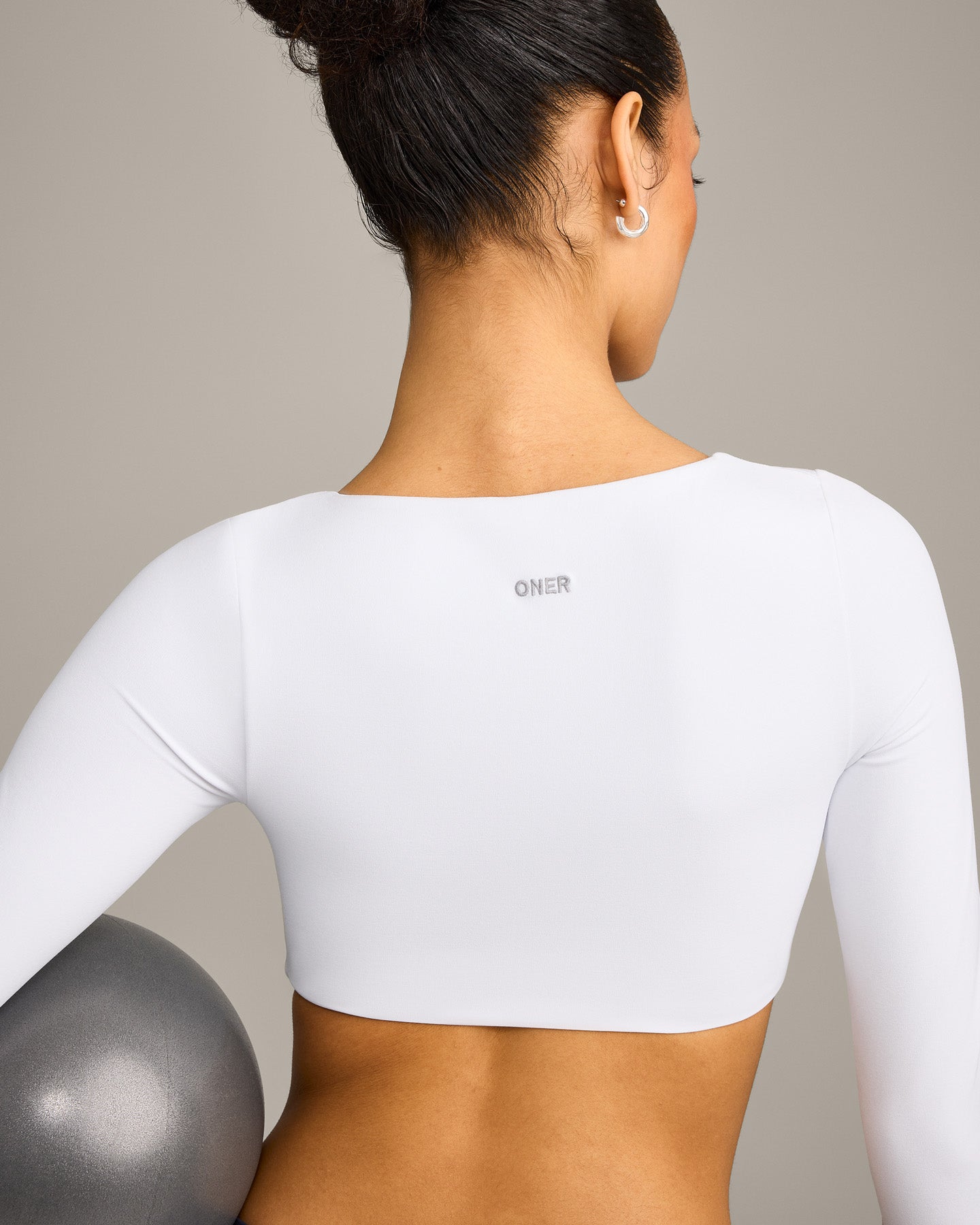 SoftMotion™ Scoop Neck Long Sleeve Crop Top with Built in Bra Shelf with Grey Logo | White
