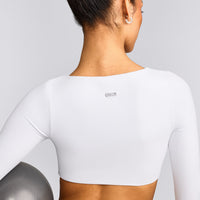 SoftMotion™ Scoop Neck Long Sleeve Crop Top with Built in Bra Shelf with Grey Logo | White