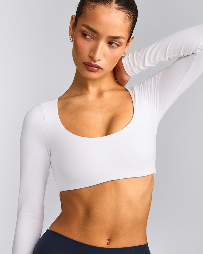 SoftMotion™ Scoop Neck Long Sleeve Crop Top with Built in Bra Shelf with Grey Logo | White
