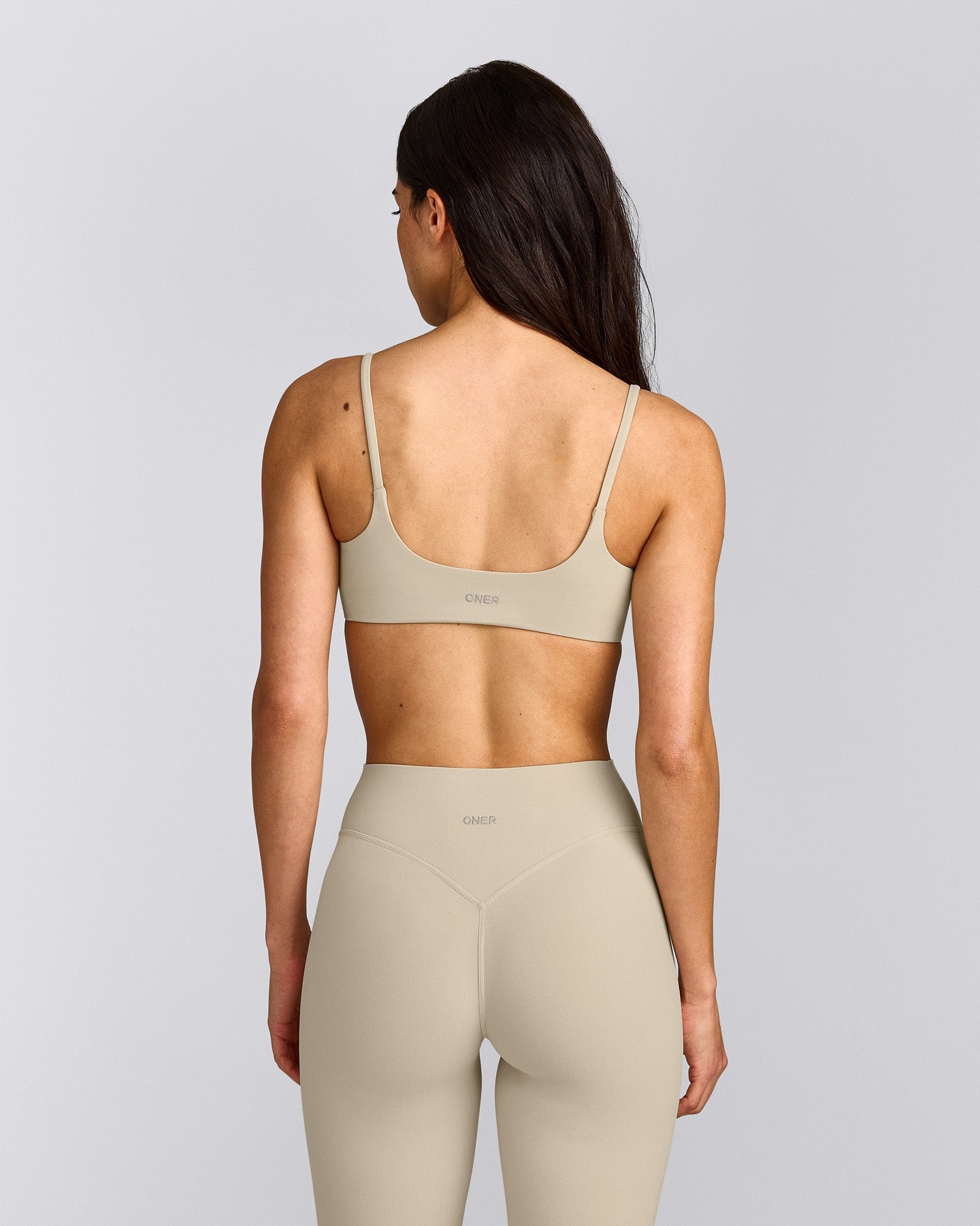 SoftMotion™ Strappy Sports Bra with Grey Logo | Oatmeal