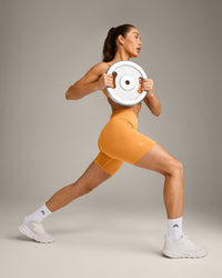 EffortlessLift™ Seamless Mid Rise Shorts with Grey Logo | Powdered Orange